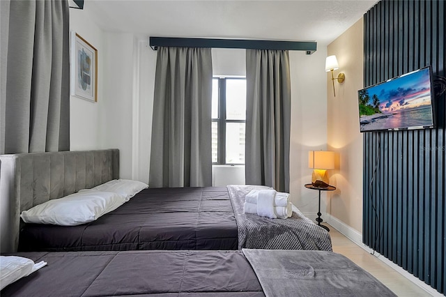 bedroom featuring wood finished floors and baseboards