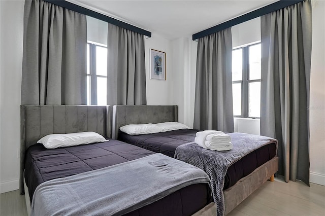 bedroom with baseboards and light wood finished floors