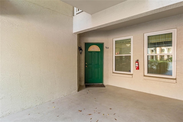 view of exterior entry featuring stucco siding