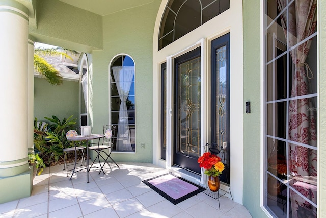 doorway to property featuring stucco siding