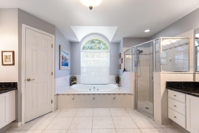 full bathroom with a bath, a shower stall, and vanity