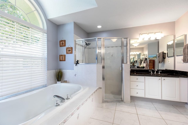 bathroom featuring vanity, a shower stall, a bath, and tile patterned floors