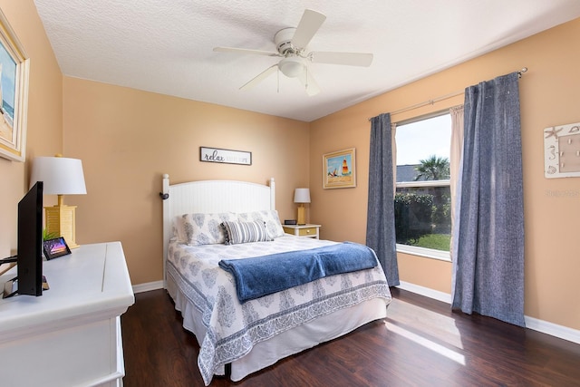 bedroom with baseboards, a textured ceiling, wood finished floors, and a ceiling fan