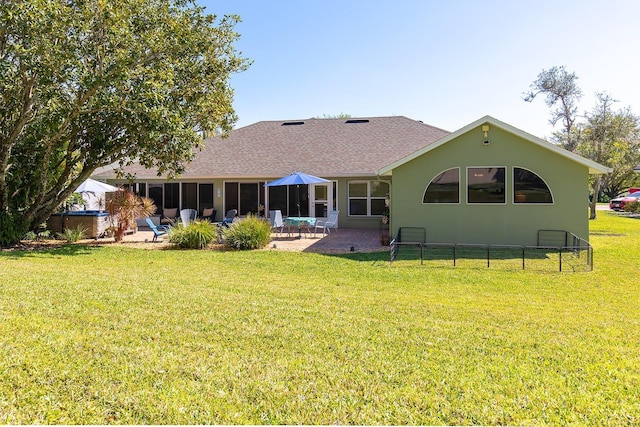 back of property featuring stucco siding, a lawn, fence, roof with shingles, and a patio area