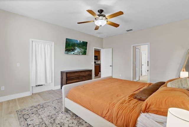 bedroom with a ceiling fan, baseboards, and light wood-type flooring