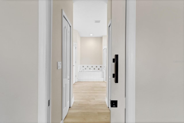 corridor with light wood-style flooring