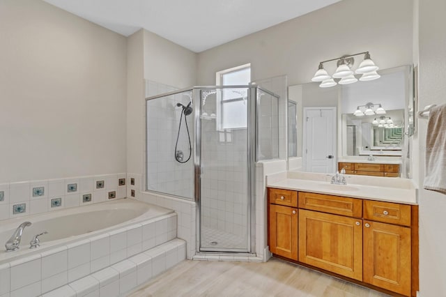 full bath featuring wood finished floors, a stall shower, vanity, and a bath