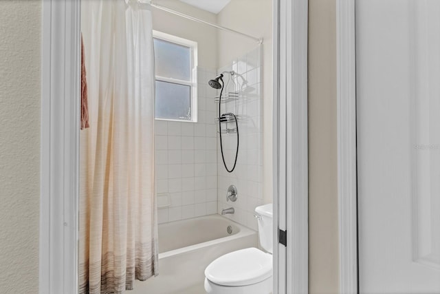 bathroom with shower / bath combination with curtain and toilet