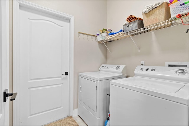 laundry room with laundry area and washing machine and clothes dryer