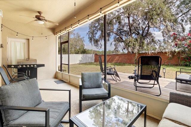 sunroom / solarium with ceiling fan