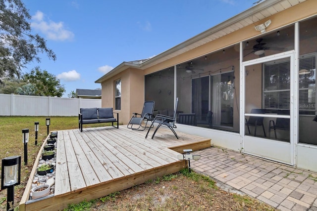 wooden terrace with fence, a yard, and a sunroom