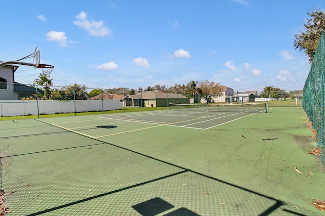 view of tennis court featuring fence