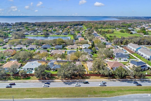 drone / aerial view featuring a residential view and a water view