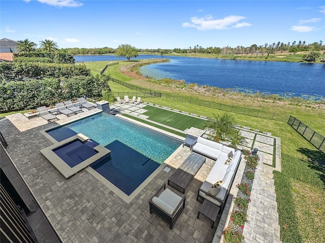 view of pool with a patio, a yard, a fenced backyard, and a water view