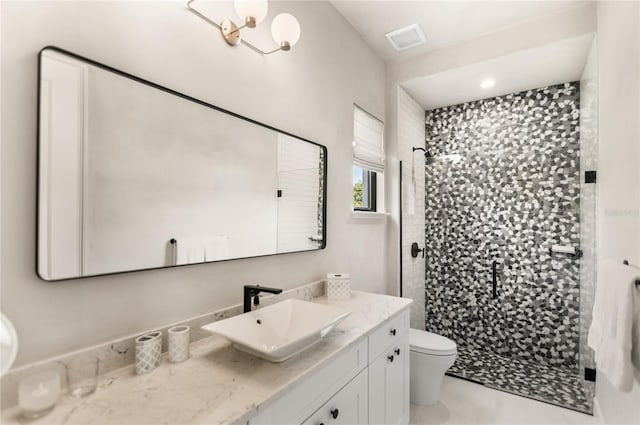 bathroom featuring visible vents, a stall shower, toilet, and vanity