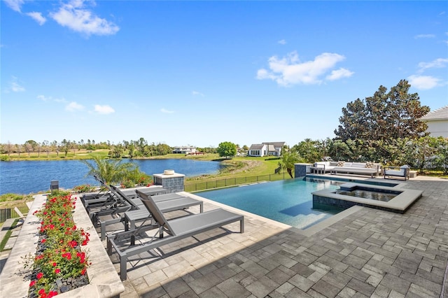 view of swimming pool featuring an in ground hot tub, fence, a patio area, and a water view