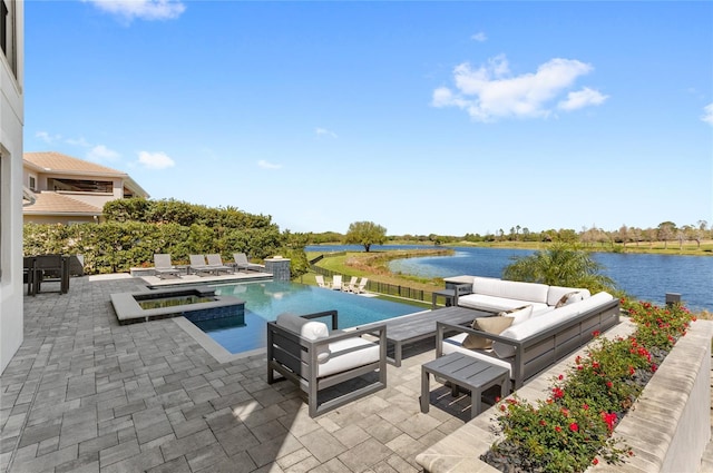 view of swimming pool featuring a pool with connected hot tub, a patio, and a water view