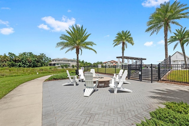 surrounding community featuring a patio, fence, a pergola, and an outdoor fire pit