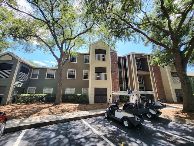 view of property featuring uncovered parking