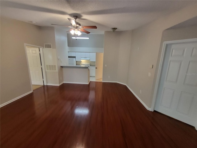 unfurnished living room with visible vents, baseboards, ceiling fan, and wood finished floors