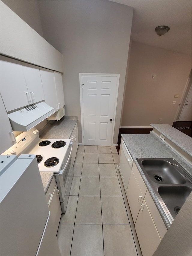 kitchen featuring high vaulted ceiling, a sink, white cabinetry, white appliances, and light tile patterned floors