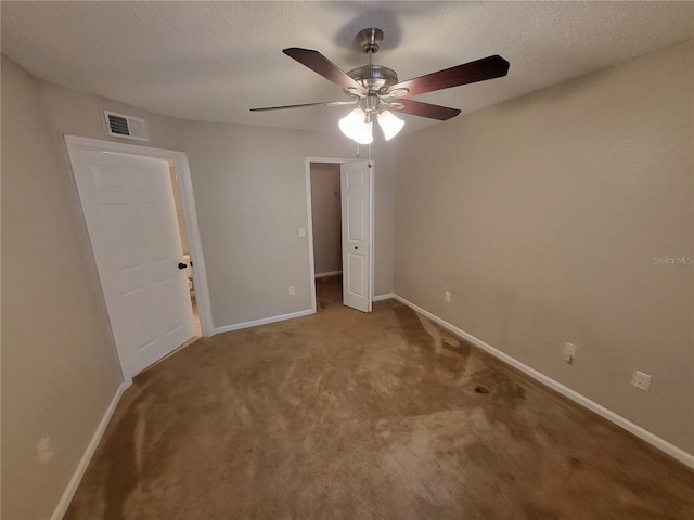 unfurnished bedroom featuring carpet, baseboards, visible vents, and a textured ceiling