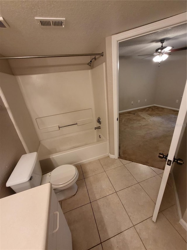 full bathroom with tile patterned floors, visible vents, toilet, and a textured ceiling