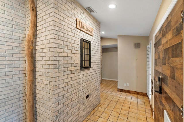 1475 Kettledrum Trl, Deltona, FL 32725 - hall with light tile patterned flooring, recessed lighting, brick wall, and baseboards