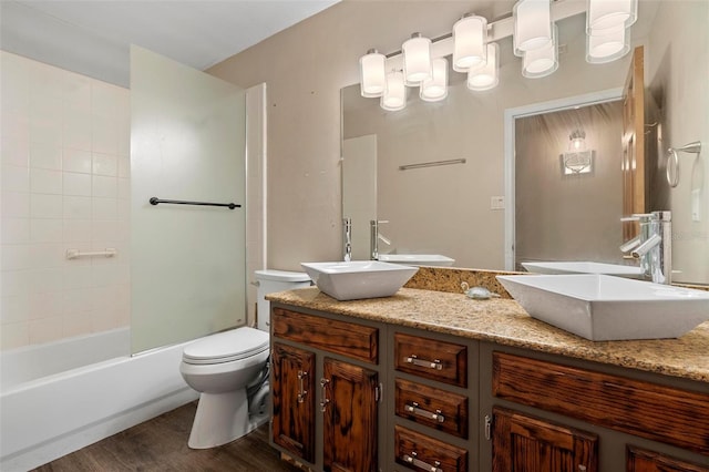 1475 Kettledrum Trl, Deltona, FL 32725 - bathroom featuring toilet, wood finished floors, double vanity, and shower / bath combination