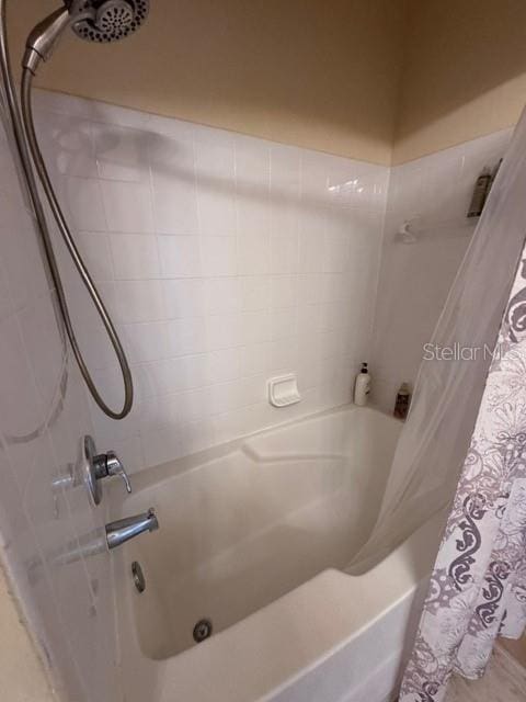 full bathroom featuring shower / bath combo with shower curtain