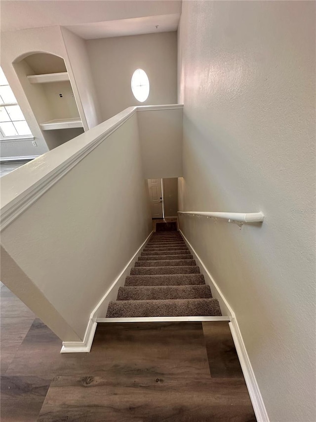 stairs with baseboards and wood finished floors