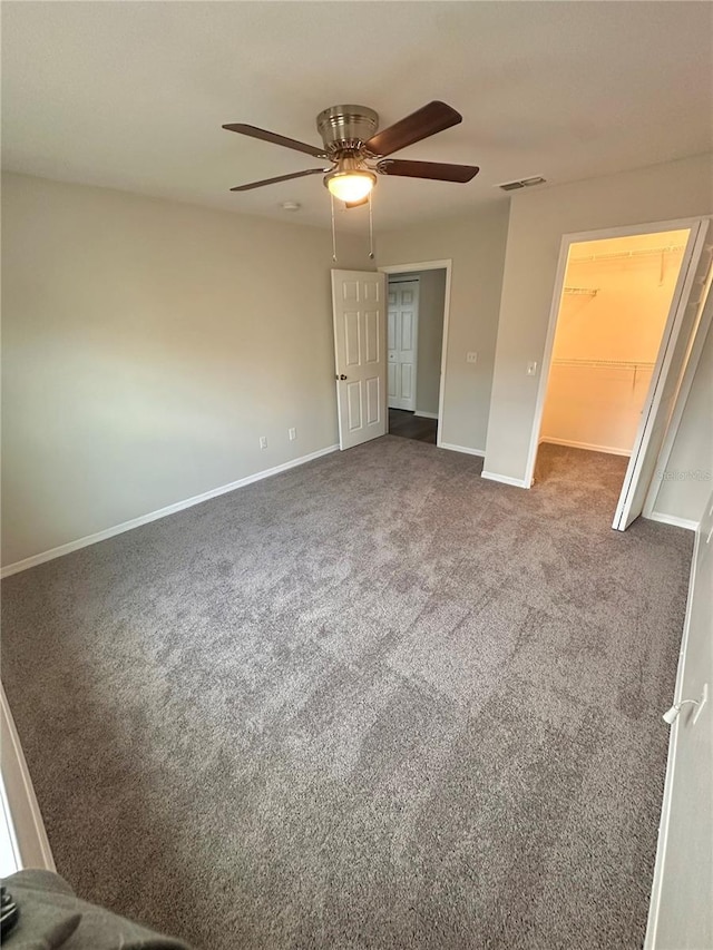 unfurnished bedroom featuring carpet flooring, baseboards, visible vents, and a closet