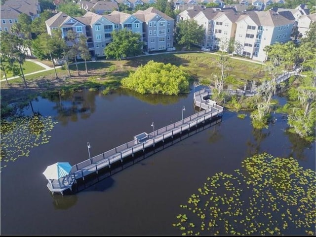 birds eye view of property with a residential view and a water view