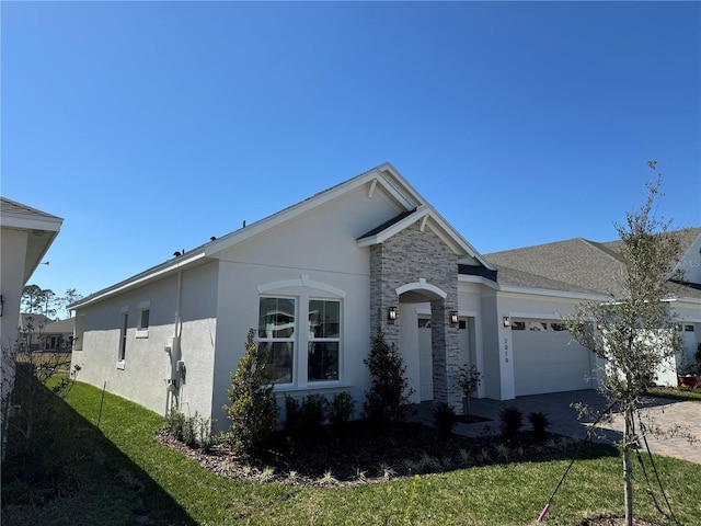 ranch-style home featuring stucco siding, driveway, stone siding, a front yard, and a garage