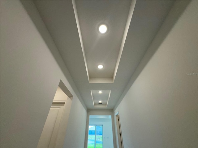 interior details with recessed lighting and a tray ceiling