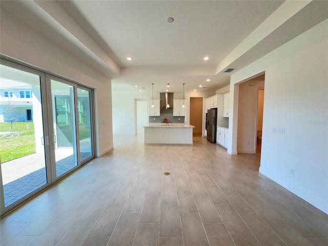 unfurnished living room featuring visible vents, recessed lighting, french doors, and baseboards