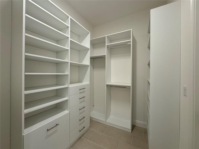 walk in closet featuring light tile patterned flooring