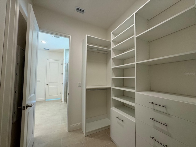 walk in closet featuring visible vents and light tile patterned flooring