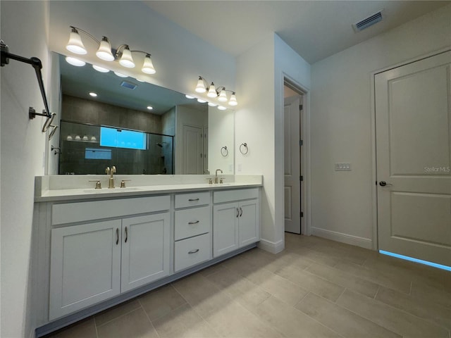 bathroom with a shower stall, double vanity, visible vents, and a sink