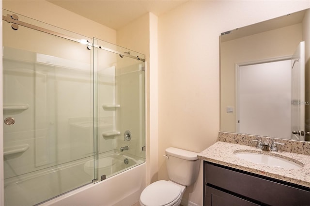 full bath with vanity, toilet, and combined bath / shower with glass door