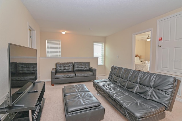 carpeted living room with baseboards