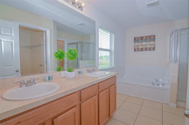 bathroom featuring tile patterned floors, visible vents, a shower stall, and a sink