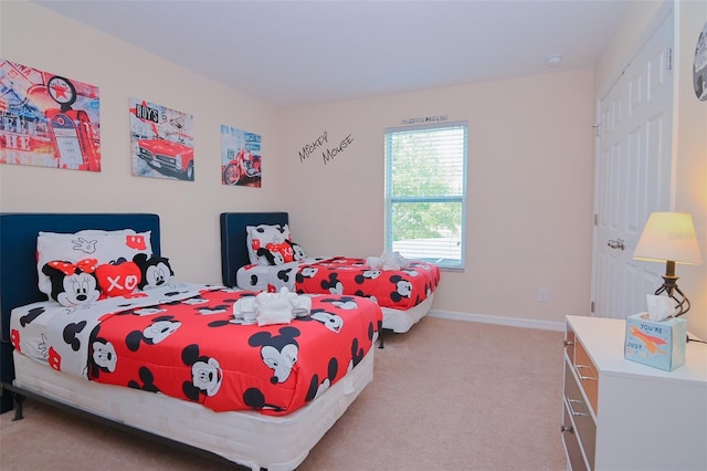 carpeted bedroom with baseboards