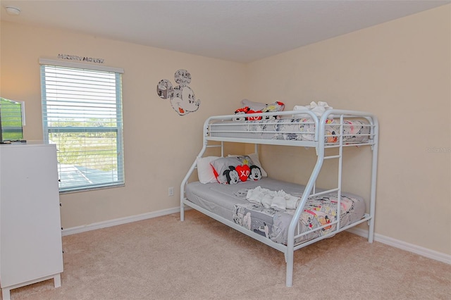 carpeted bedroom featuring baseboards