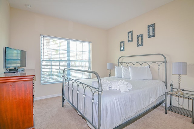 carpeted bedroom featuring baseboards