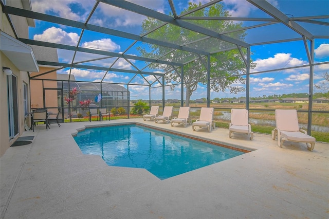 pool with glass enclosure and a patio