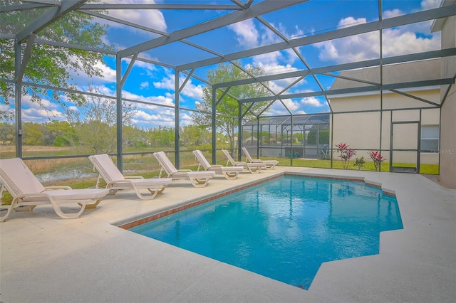 outdoor pool with glass enclosure and a patio