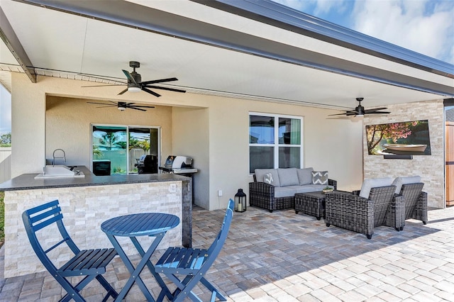 view of patio / terrace featuring a sink, an outdoor kitchen, outdoor lounge area, and ceiling fan