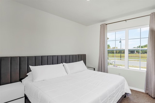 carpeted bedroom featuring baseboards