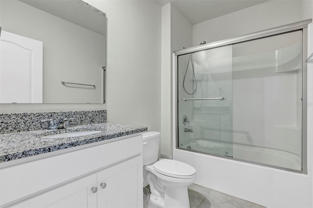 full bath with enclosed tub / shower combo, tile patterned floors, toilet, and vanity